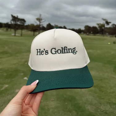 He's Golfing Trucker Hat